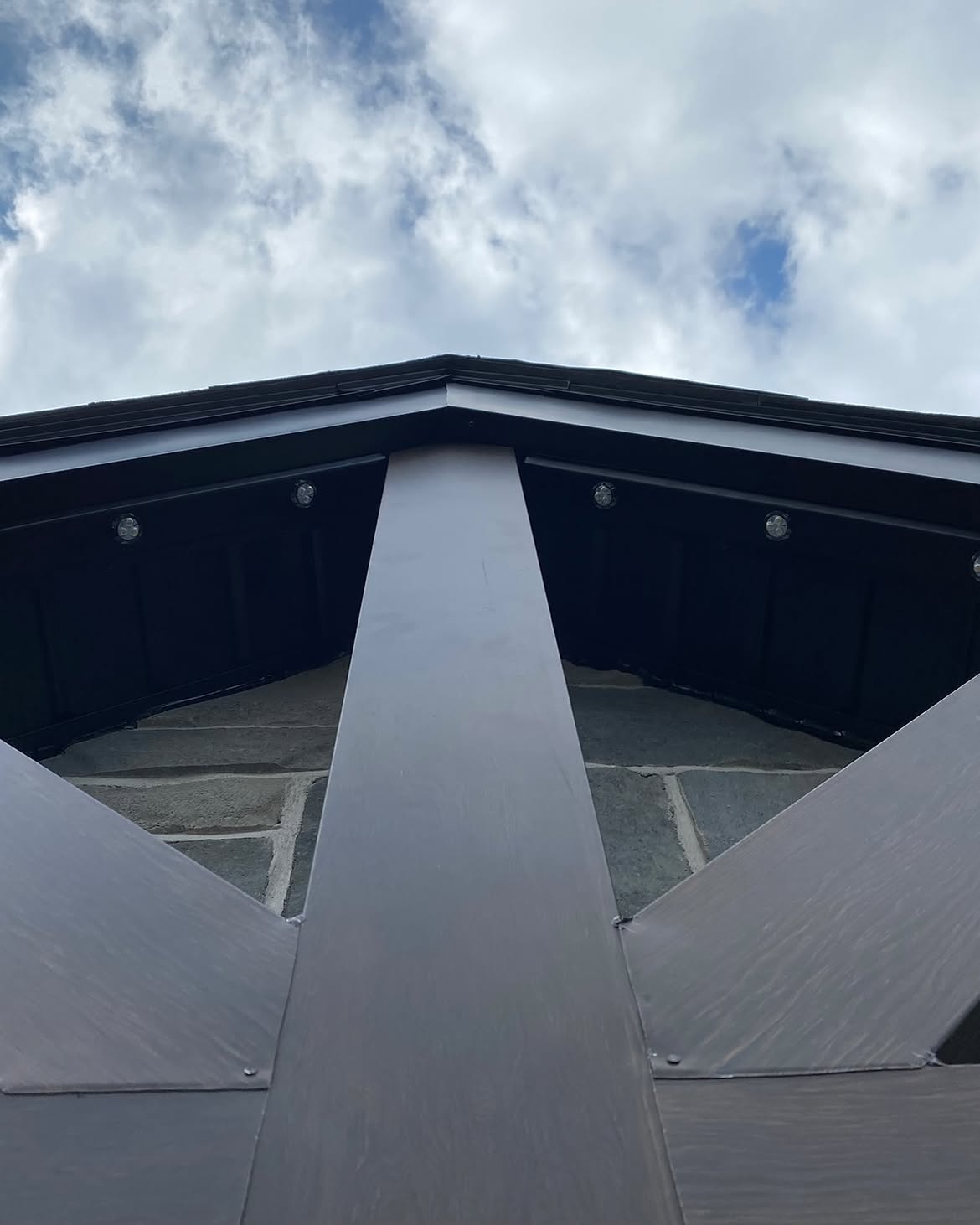 Permanent lighting track following a black gable peak