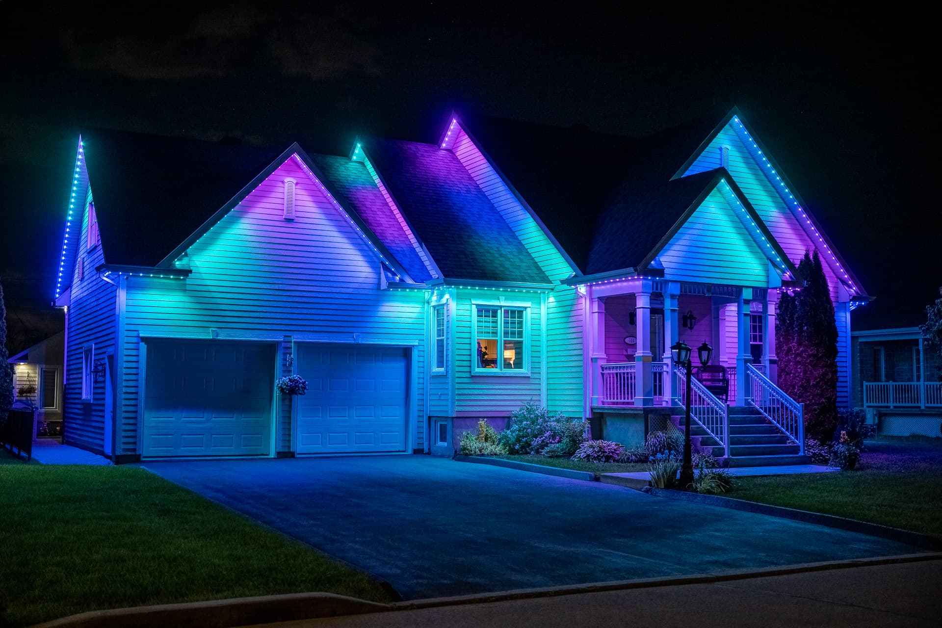 Home glowing with bright blue, cyan, and purple permanent lighting