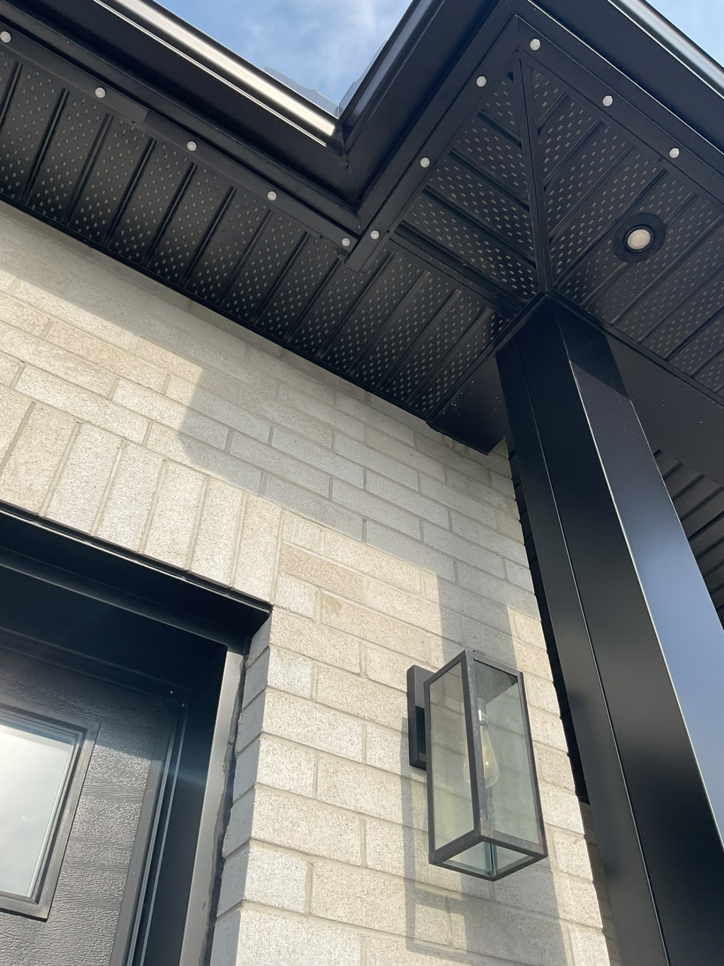 Close-up of permanent lighting track on a black soffit corner