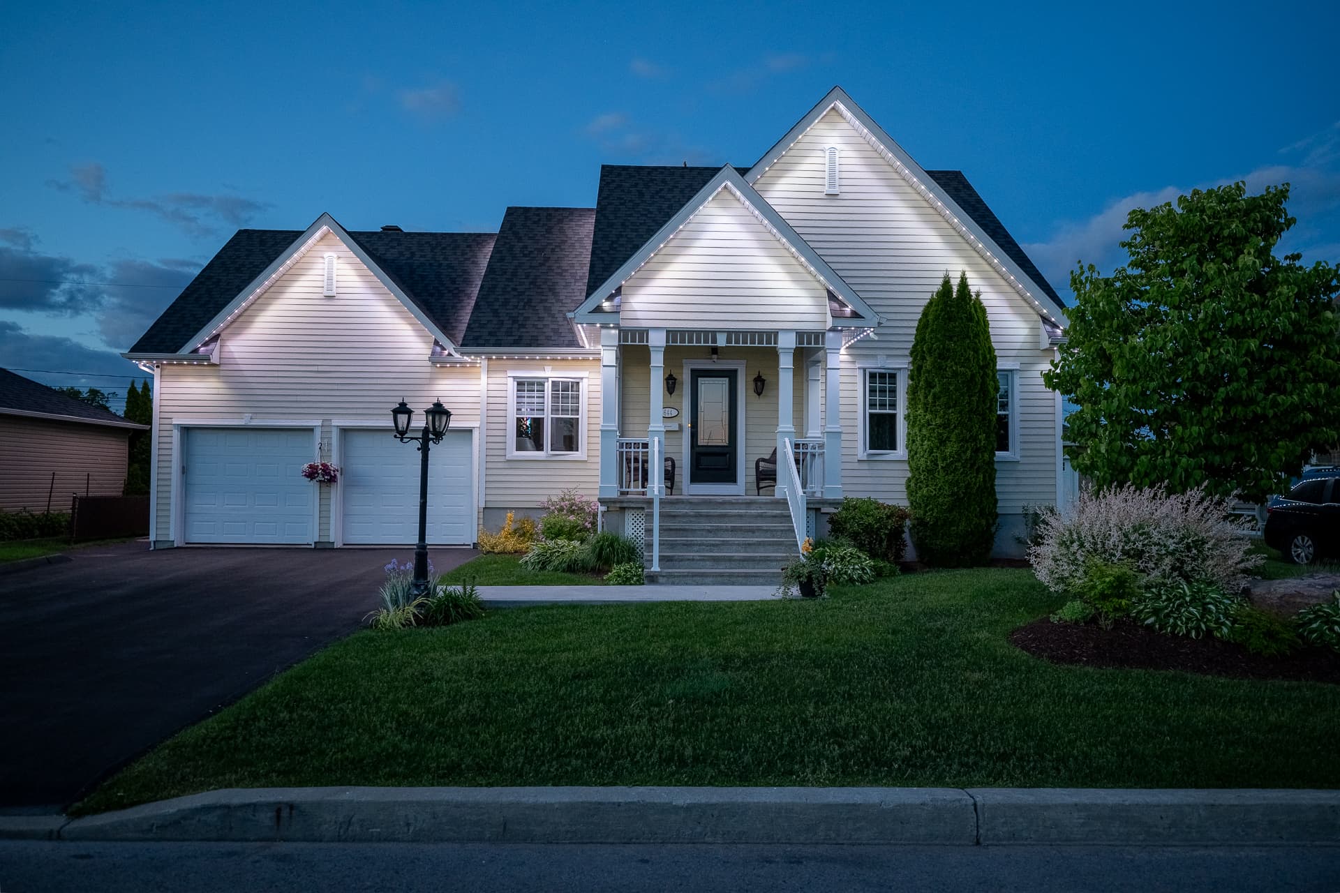 Home with clean warm white permanent roofline lighting