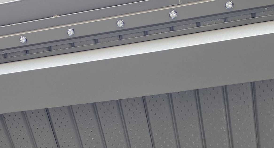 Close-up of permanent lighting track on a grey fascia